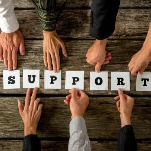 Seven hands holding each letter of “Support”
